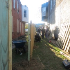Volunteers working on getting the fence up and into place.